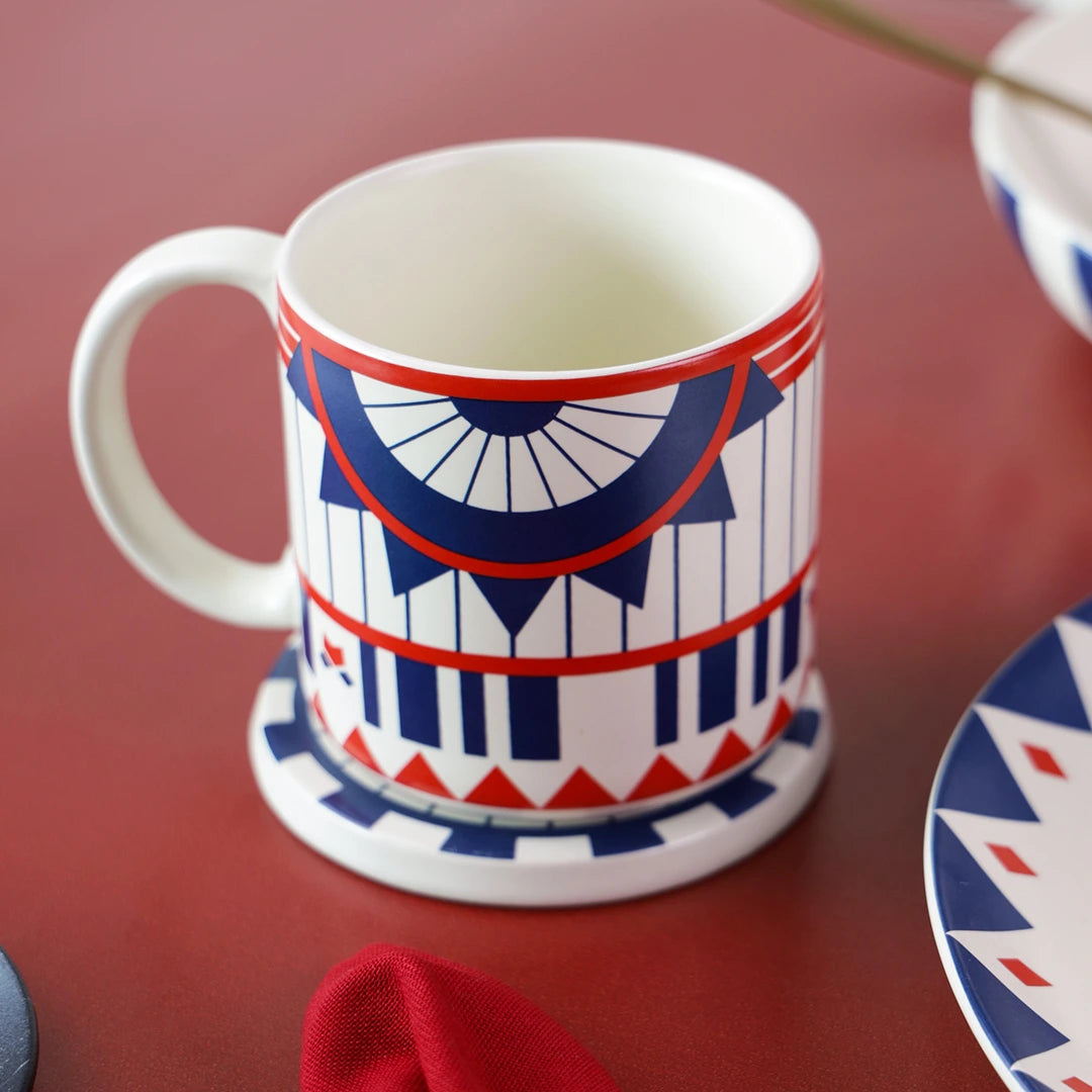 Blue & red geometric designed ceramic mugs for breakfast on top of a coaster