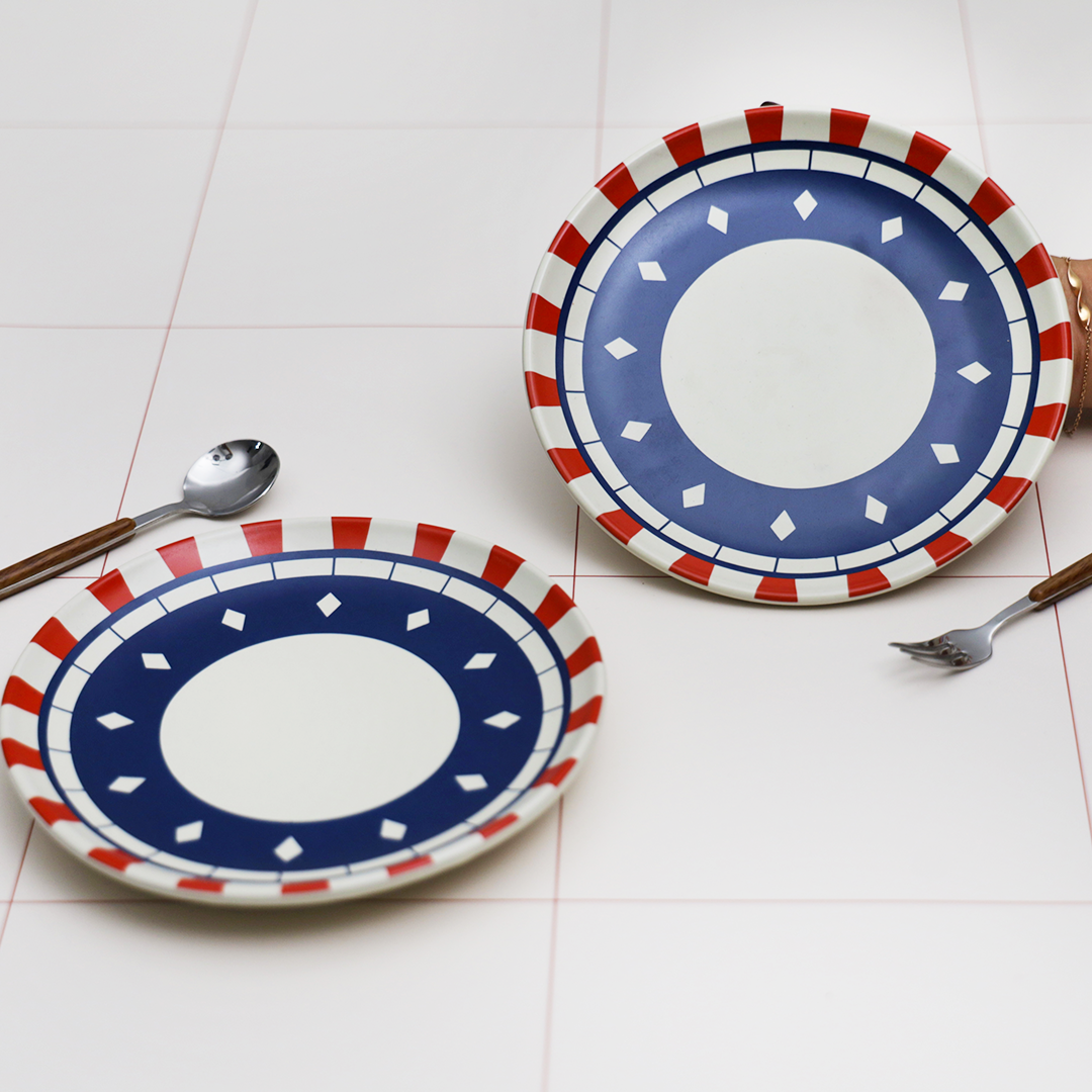 Blue and red ceramic dinnerware set featuring the CST clock