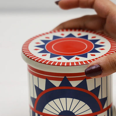 red & blue geometric patterned ceramic beverage coaster placed on top of a mug