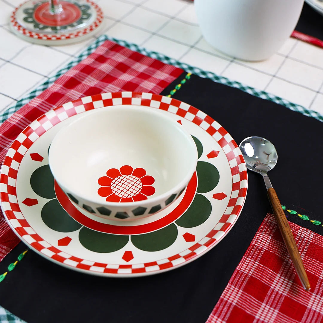 Red Flower & square patterned ceramic ip bowl with a snack plate on a black & red table mat with a spoon on the side | ceramic dinner set