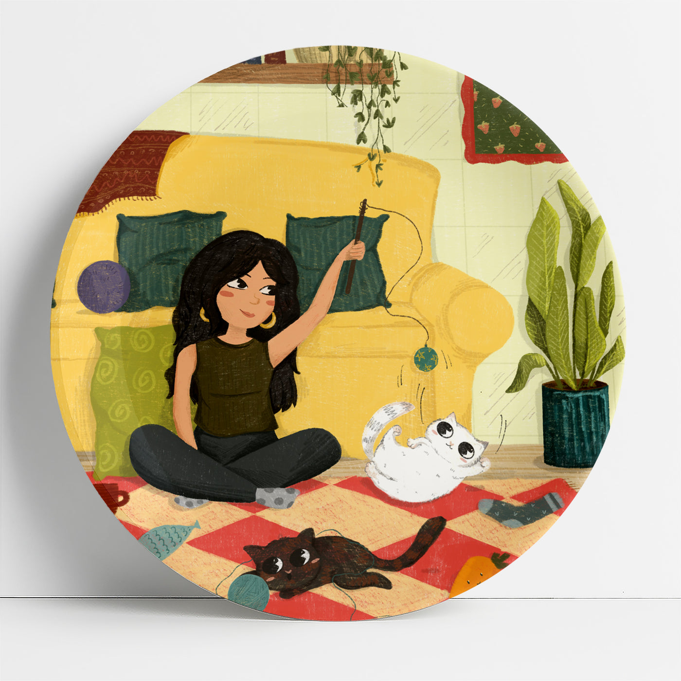 Woman playing with a cat on a picnic mat | home decor goods