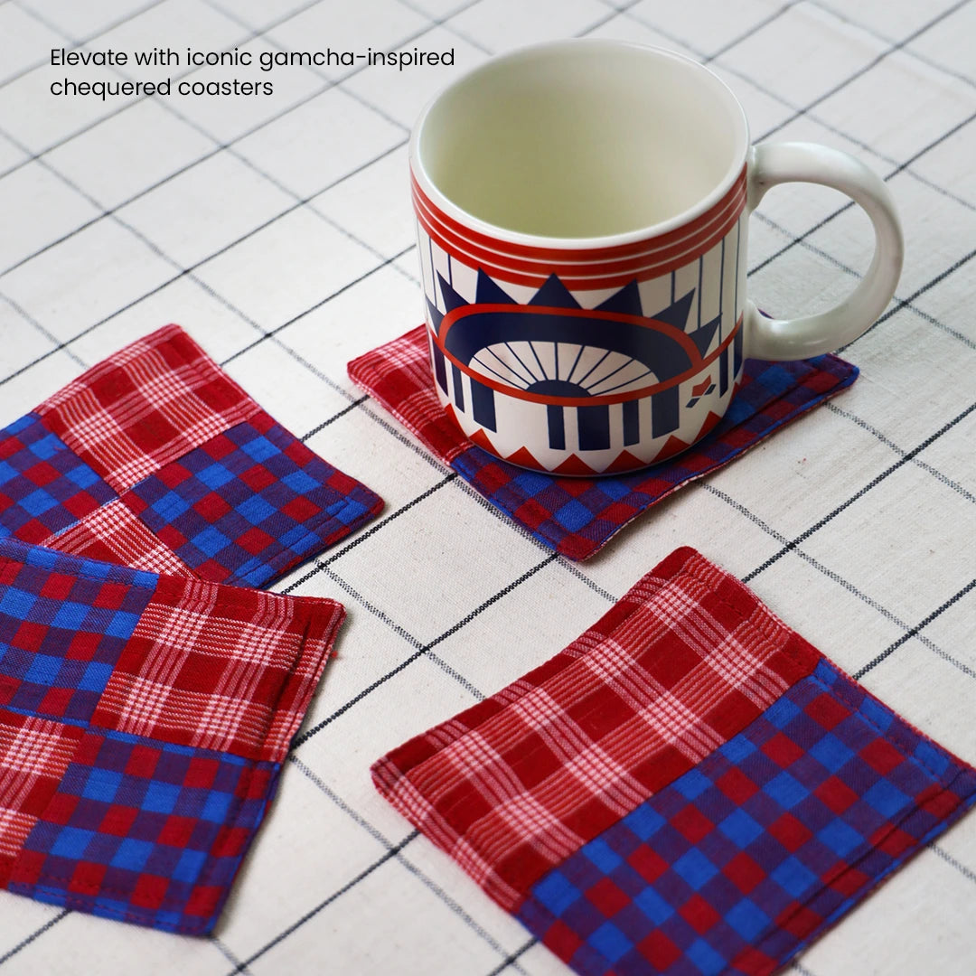 Blue mug placed on a gamcha-inspired red & blue chequered cloth coasters | Ceramic mugs