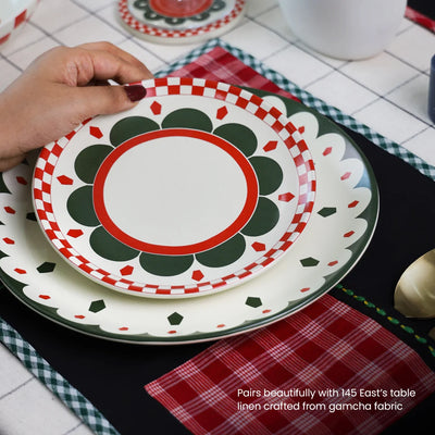 A hand holding a side plate set 