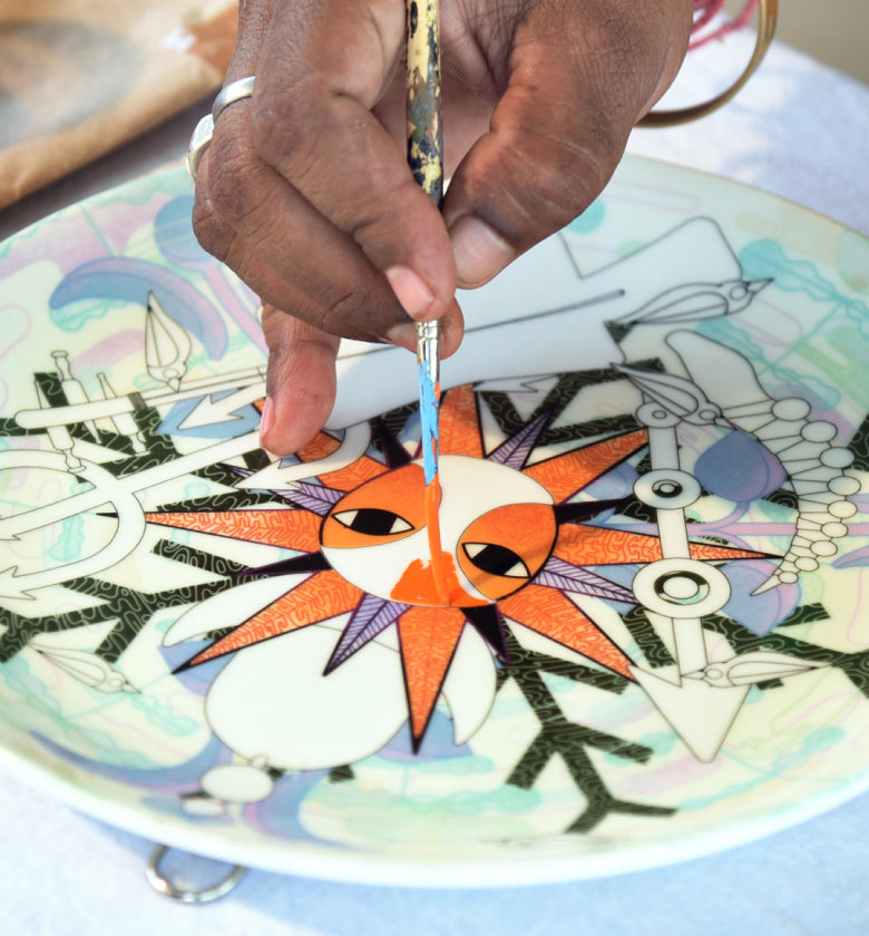 Artist hand-painting a plate