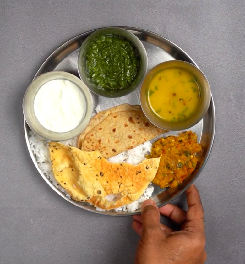A meal served on a steel thali